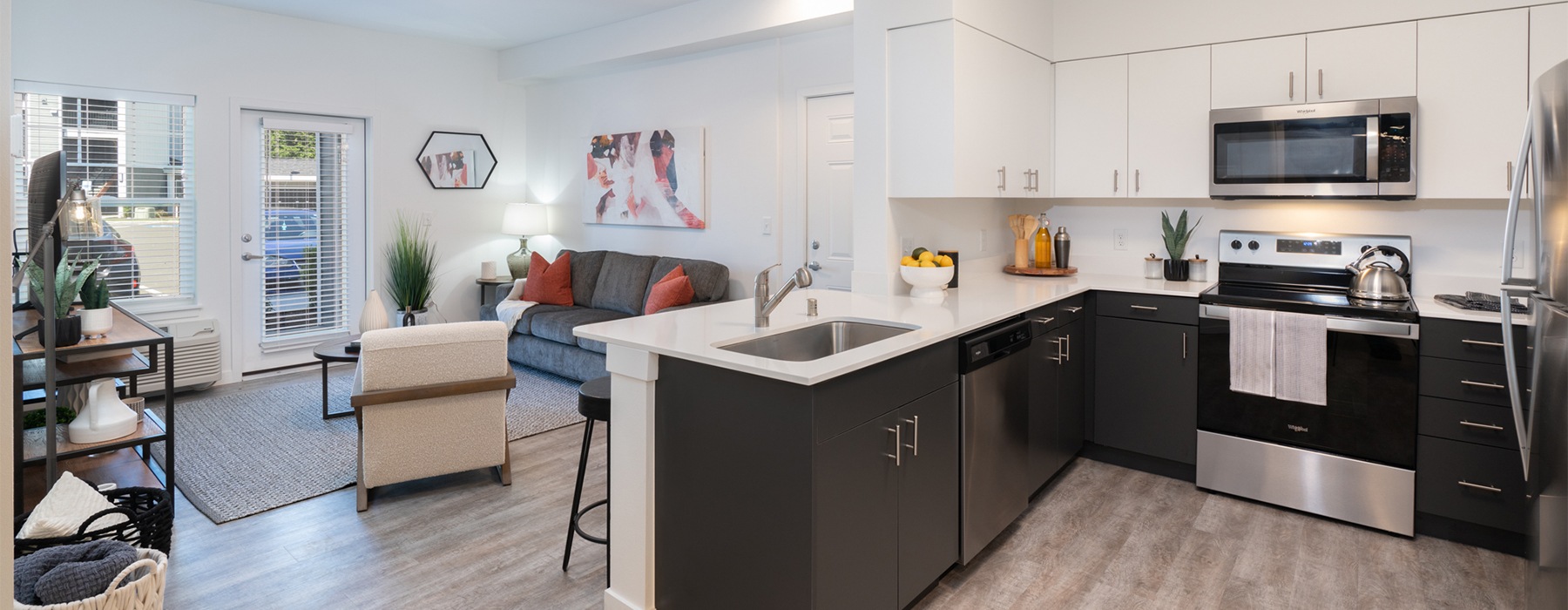 an open concept kitchen next to a living room